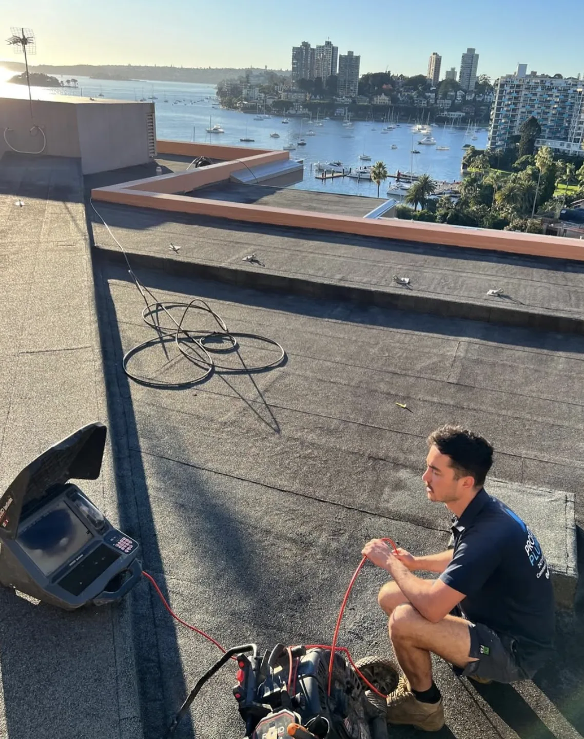 Working on a rooftop drainage outlet